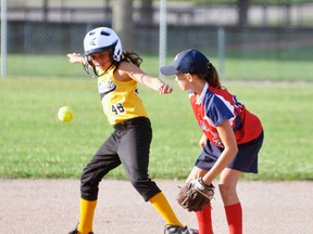 Emily Haefling of the Mitchell Squirt girls #1 team eludes a ball hit past second base during action last Monday, July 20 against St. Marys. The girls edged their visitors 12-11 to reel off their sixth win in a row.. ANDY BADER/MITCHELL ADVOCATE