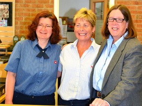 Postmaster Nadine Storey (left) and acting superintendent Liz Scott congratulate Wendy Feltz on her retirement during her last day at work at the Mitchell Post Office July 22. GALEN SIMMONS/MITCHELL ADVOCATE