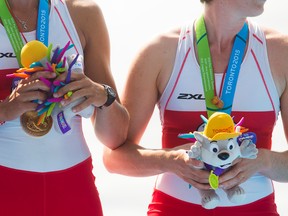 (left) Carling Zeeman and Antje Von Seydlitz of Canada hold the Pachi dolls they were awarded along with their gold medal in quadruple sculls on the final day of competition at Henley Island during the Pan Am Games in St. Catharines on Wednesday, July 15, 2015. Julie Jocsak/ St. Catharines Standard /  Postmedia Network