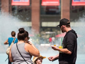 A family enjoys A Taste of Edmonton in Churchill Square.