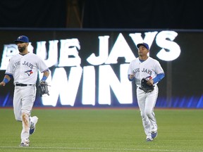 After playing on the road for most of July, Jose Bautista (left), Ezequiel Carrera (right) and the rest of the Blue Jays are back at the Rogers Centre on July 28, 2015, where they have a 28-19 record (.596) during the 2015 season. (TOM SZCZERBOWSKI/Getty Images/AFP files)