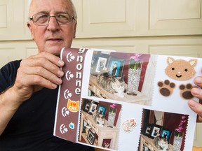 Daniel Rhealt with photos of his cat.