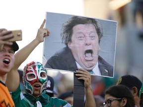 Mexico fans hold an image of head coach Miguel Herrera as they cheer before the CONCACAF Gold Cup championship soccer match between Mexico and Jamaica on July 26, 2015, in Philadelphia. (AP Photo/Michael Perez)