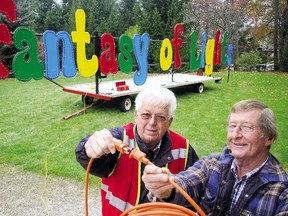 In this 2010 photo Ross Whalls, left, former St. Thomas Holiday Fantasy of Lights chairman, and volunteer Ted Patterson test the sign for the annual illuminated attraction which lights up Pinafore Park.