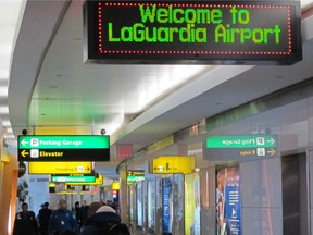 This Jan. 10, 2014 file photo shows passengers as they maneuver through one of the cramped hallways at at New York's LaGuardia Airport. (AP Photo/Frank Eltman, File)