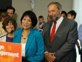 Olivia Chow, along with NDP federal leader Tom Mulcair, announces her intention to run in the October federal election for the NDP in the Spadina-fort York riding. (JACK BOLAND/Toronto Sun)