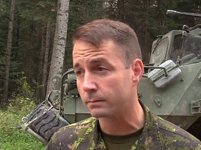 In this screengrab from video, Lt.-Col. Mason Stalker is interviewed as Canadian troops fight fires in Montreal Lake, Sask., Thursday, July 9, 2015. A high-ranking Canadian Forces officer faces serious, sex-related charges involving allegations that stem from the mentoring of military cadets. THE CANADIAN PRESS/Bill Graveland