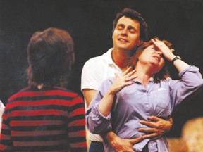 Robin Phillips holds Susan Wright as he directs the Canadian actor in a scene from Waiting For The Parade in a June 20, 1983 photograph. The John Murrell play was part of the playbill at the Grand Theatre during Phillips? season at the helm. (Free Press file photo)