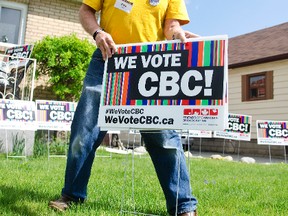 Pete Hewett plants a We Vote CBC sign on his lawn Tuesday morning. We Vote CBC is a national campaign aiming to put the future of the CBC on the agenda of the upcoming federal election. Jessica Nyznik/ Peterborough Examiner/ Postmedia Network