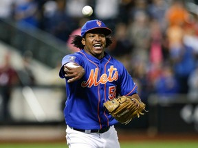 In this Sept. 10, 2014 file photo, New York Mets relief pitcher Jenrry Mejia tosses the ball to throw out Colorado Rockies' Josh Rutledge at first base to end a baseball game in New York. (AP Photo/Frank Franklin II, File)