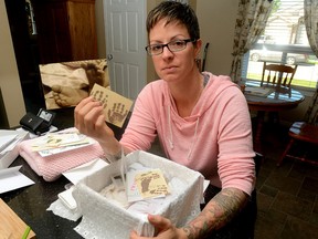 Heather Stuart shows her memory box of photos and clothing from her stillborn baby. She is raising money for Cuddle Cot, a cooling pad placed in a basket, bed, or crib that will preserve the stillborn baby?s body longer, giving the family more time to grieve. (MORRIS LAMONT, THE LONDON FREE PRESS)