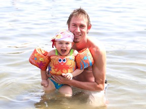 John Lappa/The Sudbury Star
Andre Leroux and his daughter, Anika, 2, cool off in Ramsey Lake at the main beach at Bell Park in Sudbury on Tuesday.