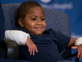 Double-hand transplant recipient eight-year-old Zion Harvey smiles during a news conference Tuesday, July 28, 2015, at The Children’s Hospital of Philadelphia (CHOP) in Philadelphia. Surgeons said Harvey of Baltimore who lost his limbs to a serious infection,  has become the youngest patient to receive a double-hand transplant. (AP Photo/Matt Rourke)