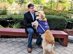 Lawyer J. Andrew Sprague, who suffers from PTSD, is pictured with his service dog, Flicka.