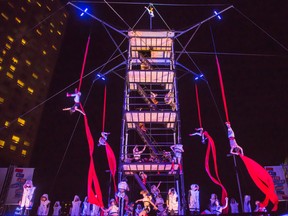 Duels: A traditional acrobatic bit featuring a tight-rope walker high above place Emilie-Gamelin, with performers spinning and tumbling in the air on a balmy summer night. (Courtesy Renald Laurin/Montreal Completement Cirque)