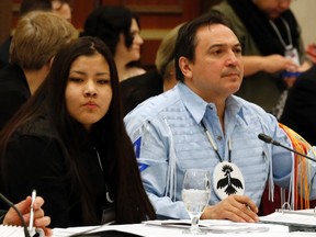 Rinelle Harper (left) waits for the start of the National Roundtable on Missing and Murdered Indigenous Women and Girls with Assembly of First Nations National Chief Perry Bellegarde earlier this year. A fundraising campaign has started to help Harper and her family. (REUTERS/Chris Wattie file photo)