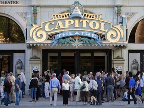 People enter the Capitol Theatre to see "The Book of Mormon" musical Tuesday, July 28, 2015, in Salt Lake City. The biting satirical musical that mocks Mormons has finally come to the heart of Mormonlandia, starting a sold-out, two-week run Tuesday at the Salt Lake City theater two blocks from the church's flagship temple and headquarters. (AP Photo/Rick Bowmer)