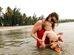 In this May 23, 2015 photo, Amber Hunt plays with her 17-month-old son Hunt Van Benschoten at a beach in San Juan, Puerto Rico. No matter how experienced a traveler you are, an overseas trip taken with a baby or toddler requires changes in planning, expectations and itineraries.  (Elijah Van Benschoten via AP)