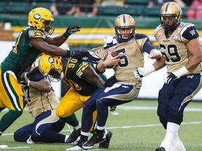 Edmonton Eskimos' Odell Willis sacks Winnipeg Blue Bombers' Drew Willy during last Saturday's game. Bomber fans have been in a foul mood ever since. (Ian Kucerak/Postmedia Network)