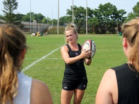 Julia Greenshields, a 23-year-old member of Rugby Canada's national women's program, passes on a few tips to the Sarnia Saints U18 girl's side at Norm Perry Park on Tuesday July 28, 2015 in Sarnia, Ont. (Terry Bridge/Sarnia Observer/Postmedia Network)