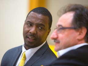 London Lightning coach Carlos Knox, shown here in this file photo talking with team owner Vito Frijia, has been fired, the team announced Wednesday. (Free Press file photo)