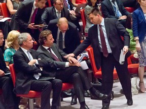 Ukraine Foreign Minister Pavlo Klimkin, right, makes a sympathetic gesture to Belgium Foreign Minister Benedicte, center, as he prepares to speak before the Security Council after Russia vetoed a draft resolution in the council to create a tribunal to prosecute those found responsible for the downing of Malaysia Airlines Flight 17 over eastern Ukraine, Wednesday, July 29, 2015 at U.N. headquarters. (AP Photo/Bebeto Matthews)