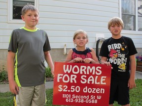 Kristopher, Kristina and Clayton Cadieux were served a bylaw notice threatening a $240 fine if they did not take their sign advertising their worm business on Tuesday, July 28, 2015  in Cornwall, Ont. The kids have been selling worms on their front doorstep for a little over a year. Brent Holmes/Postmedia Network Files