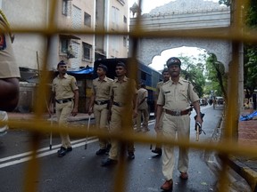 Indian policemen patrol a road leading to the residence of Yakub Memon, a key plotter of the Mumbai bomb attacks which killed hundreds of people in 1993, in Mumbai on July 30, 2015. India on July 30 executed convicted bomb plotter Yakub Memon for his role in a series of co-ordinated attacks that killed hundreds of people in Mumbai in 1993, television stations reported. Memon was hanged at Nagpur jail in the western state of Maharashtra in the early hours of the morning, according to the NDTV and CNN-IBN news channels, after last-ditch pleas for clemency were rejected.  AFP PHOTO / INDRANIL MUKHERJEE