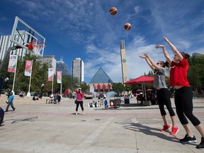 Canadian Senior Women's Basketball Team members Michelle Plouffe (in grey) and Katherine Plouffe shoot baskets in Churchill Square, in Edmonton Alta. on Wednesday July 29, 2015. The sisters were taking part in a press conference for the 2015 FIBA Americas Women's Basketball Championships, which will be held in Edmonton August 9 - 16. David Bloom/Edmonton Sun/Postmedia Network
