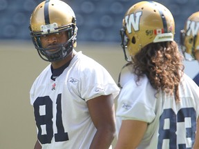 Winnipeg Blue Bombers slotback Cory Watson (l) and Winnipeg Blue Bombers wide receiver Julian Feoli-Gudino confer during CFL football practice in Winnipeg, Man. monday August 04, 2014.
Brian Donogh/Winnipeg Sun/Postmedia