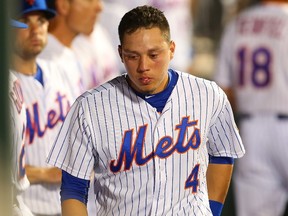 Wilmer Flores of the New York Mets looks on in the dugout in the ninth inning duirng the game against the San Diego Padres at Citi Field on July 29, 2015. (Mike Stobe/Getty Images/AFP)