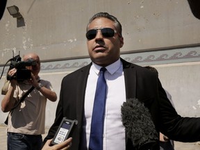 Canadian Al-Jazeera English journalist Mohamed Fahmy, speaks to the media in front of Tora prison, in Cairo, Egypt, Thursday, July 30, 2015. (AP Photo/Nariman El-Mofty)