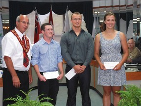 Elgin County Warden Paul Enns, left, congratulates winners of the International Plowing Match Legacy Agricultural Scholarships, Michael Jenkins of Malahide, Travis Caughell of Southwold and Anita Rastapkevicius of West Elgin.