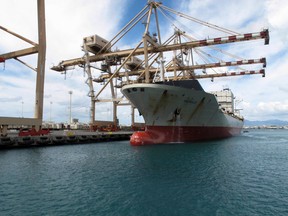 In this Monday, Sept. 16, 2013 photo, a Maston ship sits in Honolulu Harbor near the site of a molasses spill. A major shipping company will pay the state more than $15 million for a 2013 molasses spill in Honolulu Harbor, Hawaii’s attorney general said July 29, 2015. (AP Photo/Oskar Garcia)