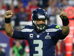 Seattle Seahawks quarterback Russell Wilson celebrates his touchdown pass to wide receiver Chris Matthews (not pictured)  in the final seconds of the first half against the New England Patriots during the NFL Super Bowl XLIX football game in Glendale, Arizona, February 1, 2015.  (REUTERS)