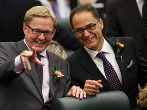 David Eggen (left), Minister of Education and Minister of Culture and Tourism, and President of Treasury Board and Minister of Finance Joe Ceci wave to a colleague before the Speech From The Throne was read on the floor of the Alberta Legislature by Lt.-Gov. Lois Mitchell in Edmonton, Alta., on Monday June 15, 2015. Ian Kucerak/Edmonton Sun