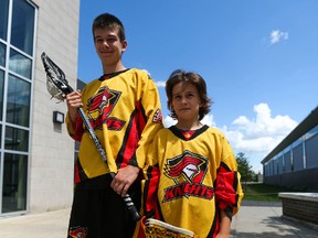 Eleven-year-old Nepean Knights lacrosse player Willem Firth and teammate Matt Clavet, 12, pose for a photo at Carleton University on Thursday, July 30, 2015. The two boys will represent Ontario at the peewee level in next week's National Lacrosse Championships of Canada in Whitby, Ont. The duo made the 18-man roster after being selected from a group of 150 11 and 12-year-old players from Ontario. (Chris Hofley/Ottawa Sun)