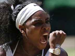 Serena Williams of the United States celebrates winning a point against Garbine Muguruza of Spain during the women's singles final at the All England Lawn Tennis Championships in London on July 11, 2015. (AP Photo/Pavel Golovkin)