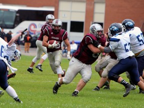 Limestone District Grenadiers running back Harry Robinson finds a gap against the Oshawa Hawkeyes during an Ontario Varsity Football League playoff game at Loyalist Collegiate on July 25. The Grenadiers defeated the Hawkeyes 29-7. (Steph Crosier/The Whig-Standard)