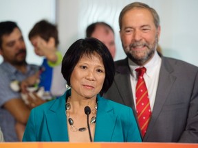 Olivia Chow, left, and NDP Leader Tom Mulcair hold a press conference in Toronto on Tuesday, July 28, 2015. Former MP Olivia Chow is making a comeback to the NDP ahead of the upcoming federal election. Chow announced she's running in the Toronto riding of Spadina-Fort York. THE CANADIAN PRESS/Darren Calabrese