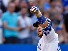 Toronto Blue Jays catcher Russell Martin points to the crowed after hitting a solo home run against the Kansas City Royals at Rogers Centre on July 30, 2015. (THE CANADIAN PRESS/Nathan Denette)
