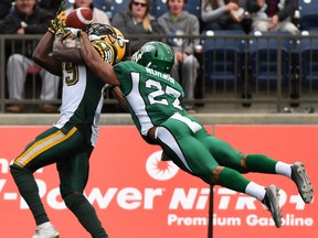 Edmonton Eskimos wide-reciever Bryan Mitchell reaches for the ball as Saskatchewan Roughriders Marrio Norman during the Northern Kickoff pre-season game at SMS Equipment Stadium in Fort McMurray on Saturday June 13, 2015.  Dale MacMillan/Edmonton Sun