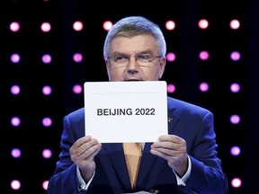 Thomas Bach, President of the International Olympic Committee, announces Beijing as the city to host the 2022 Winter Olympics during the 128th International Olympic Committee Session, in Malaysia's capital city of Kuala Lumpur on July 31, 2015. (REUTERS/Edgar Su)