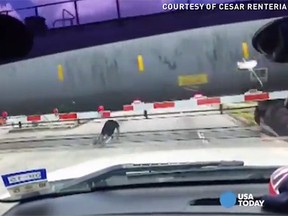 A man was caught on video repeatedly rolling underneath a train as it barrelled down the tracks in Texas. (USA Today/YouTube screengrab)