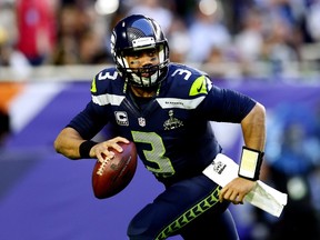 Russell Wilson #3 of the Seattle Seahawks looks for a pass in the second quarter against the New England Patriots during Super Bowl XLIX at University of Phoenix Stadium on February 1, 2015 in Glendale, Arizona.   Kevin C. Cox/Getty Images/AFP