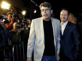 Author Stephen King (L) and cast member Donnie Wahlberg arrive for the U.S. premiere of the film "Dreamcatcher" March 19, 2003 in Los Angeles. REUTERS/Robert Galbraith