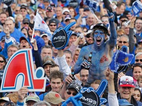 A fan painted with the Quebec Nordiques colors cheers during the Blue March rally, held to pressure the federal government to invest in the return of the NHL team, on the Plains of Abraham in Quebec City, in an October 2, 2010 file photo. (REUTERS/Mathieu Belanger/Files)