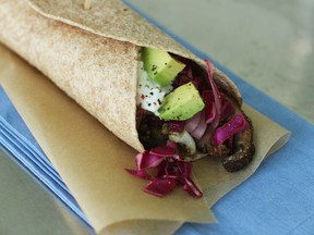 This July 13, 2015 photo shows veggie burritos in Concord, N.H. This recipe by Melissa d'Arabian uses high heat, which brings out the natural sweetness of the vegetables. (AP Photo/Matthew Mead)