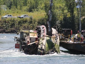 After over a month, the extraction of the capsized tugboat, Lac Manitoba, began on Friday, July 31, 2015  in Cornwall, Ont. Brent Holmes/Cornwall Standard-Freeholder/Postmedia Network
