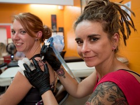 Ness Hornung tattoos a semicolon butterfly onto Mandie Gallop’s shoulder in support of suicide prevention at Juicy Quill Tattoo and Piercing in Stony Plain on Monday, July 27. The Semicolon Project is an international campaign to raise awareness about suicide prevention and mental illness. Juicy Quill Tattoo and Piercing in Stony Plain will be offering semicolon tattoos from Aug. 1 to Sept. 10 to help raise money for the Coordinated Suicide Prevention Program, which focuses on suicide awareness and prevention in the tri-area. - Yasmin Mayne, Reporter/Examiner